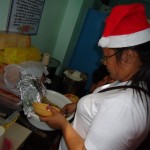 Glenda dishing up pancit