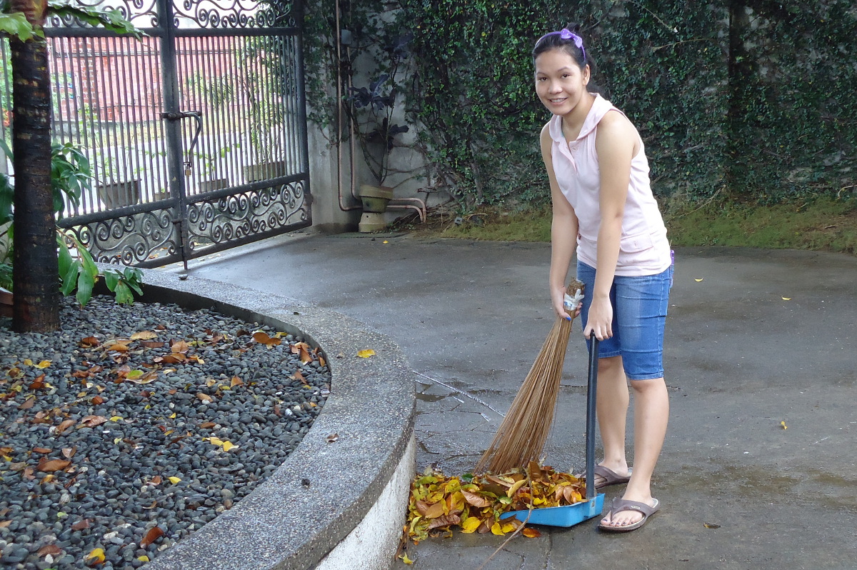 Jean helping the maid with sweeping the driveway